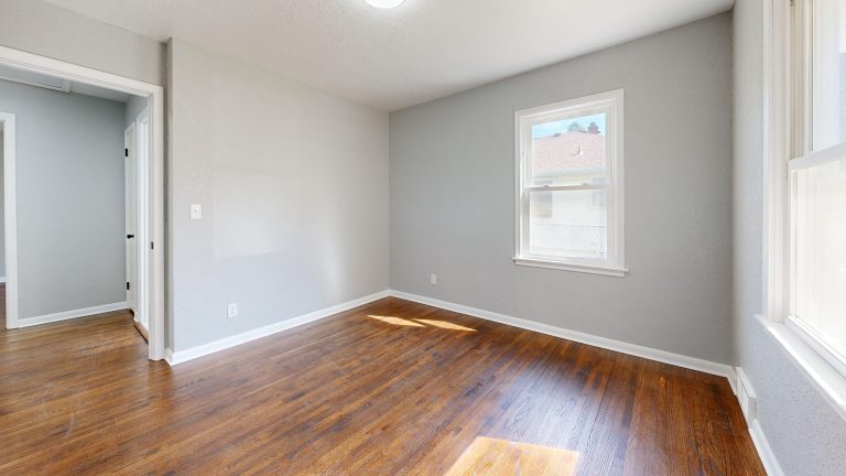 Freshly refinished honey oak flooring in an empty Utah room