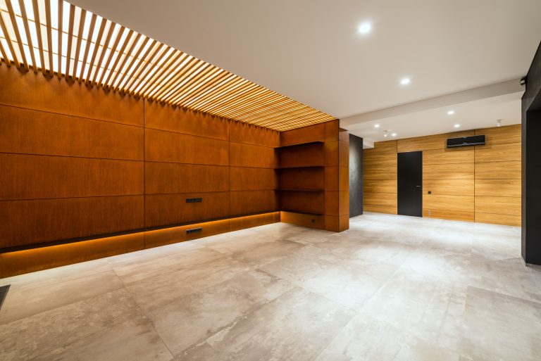 Large-format pale limestone flooring in a modern Utah interior with timber wall panelling