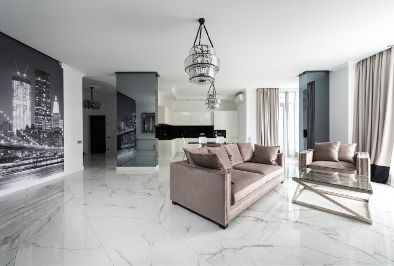 Large-format white marble-look porcelain tile flooring in a Utah living room
